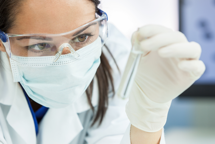 a woman holding a test tube