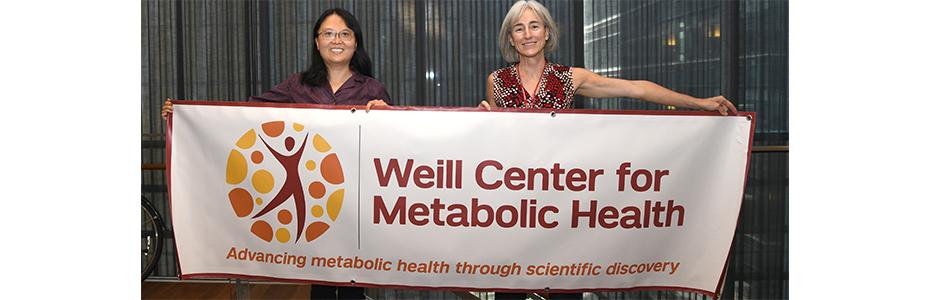 Dr. Alonso and Mingming Hao holding up Center for Metabolic Health banner